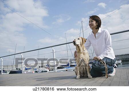 Young woman and Labrador retriever View Large Photo Image Stock Photograph - Young woman and Labrador retriever. Fotosearch