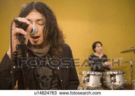 Stock Image - Rock band in rehearsal. Fotosearch