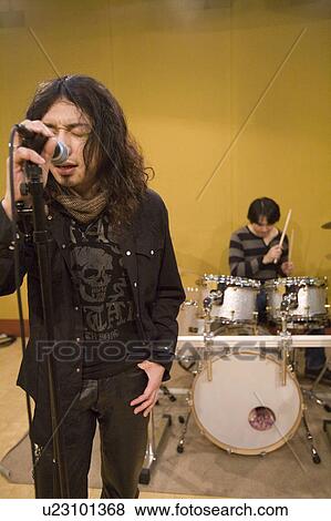 Stock Photo - Rock band in rehearsal. Fotosearch