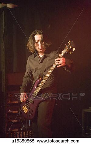 Young man playing bass guitar on stage View Large Photo Image Stock Photography - Young man playing bass guitar on stage. Fotosearch