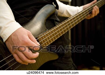 Young man playing bass guitar View Large Photo Image Picture - Young man playing bass guitar. Fotosearch