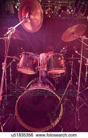 Young man playing drums on stage View Large Photo Image Stock Photograph - Young man playing drums on stage. Fotosearch