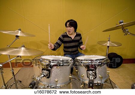 Young man playing drums View Large Photo Image Stock Image - Young man playing drums. Fotosearch