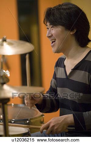 Young man playing drums View Large Photo Image Stock Photography - Young man playing drums. Fotosearch