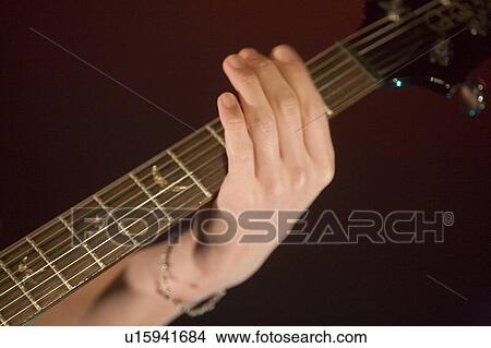 Picture - Young man playing electric guitar on stage. Fotosearch