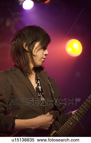 Young man playing electric guitar on stage View Large Photo Image Stock Photography - Young man playing electric guitar on stage. Fotosearch