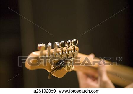 Young man playing electric guitar View Large Photo Image Stock Photo - Young man playing electric guitar. Fotosearch