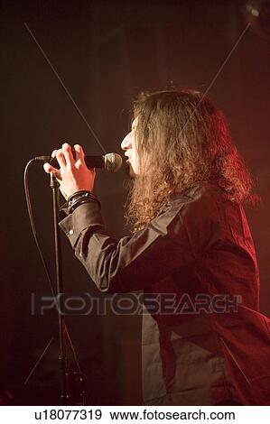 Stock Photo - Young man singing on stage. Fotosearch