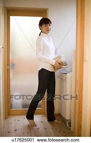 Young woman carrying towels View Large Photo Image Stock Image - Young woman carrying towels. Fotosearch