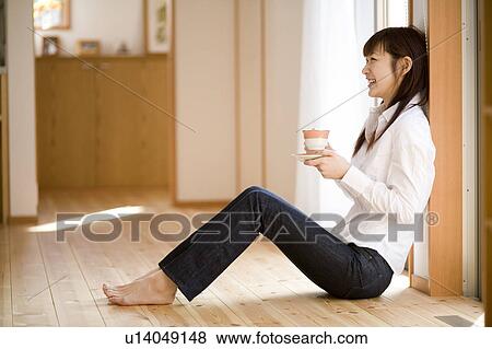 Young woman having cup of coffee View Large Photo Image Stock Photo - Young woman having cup of coffee. Fotosearch