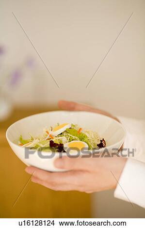 Young woman holding bowl of salad View Large Photo Image Picture - Young woman holding bowl of salad. Fotosearch