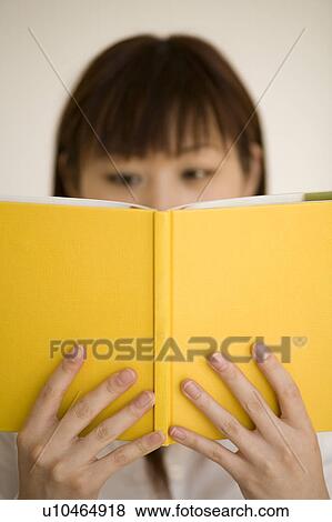 Stock Photo - Young woman reading book. Fotosearch