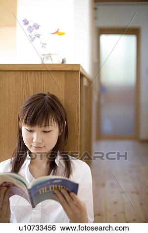 Young woman reading book View Large Photo Image Stock Photograph - Young woman reading book. Fotosearch