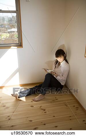 Young woman reading magazine View Large Photo Image Stock Image - Young woman reading magazine. Fotosearch
