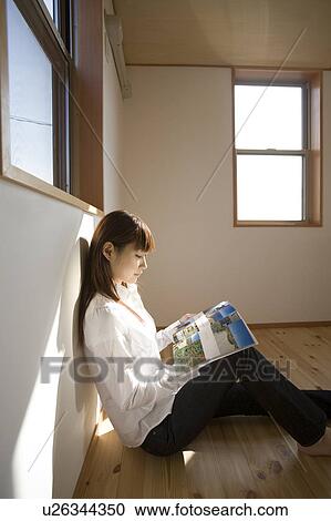 Young woman reading magazine View Large Photo Image Stock Image - Young woman reading magazine. Fotosearch
