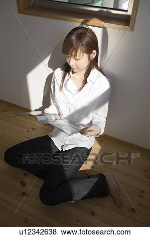 Young woman reading magazine View Large Photo Image Stock Photo - Young woman reading magazine. Fotosearch