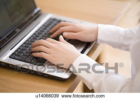 Young woman using computer View Large Photo Image Stock Photo - Young woman using computer. Fotosearch