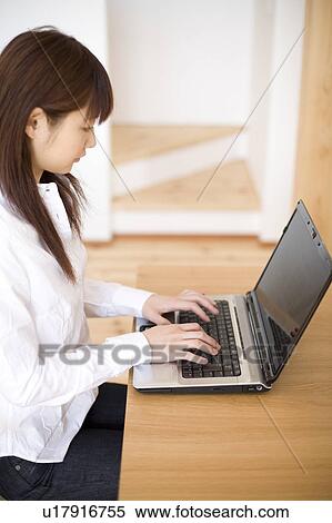 Stock Photography - Young woman using computer. Fotosearch