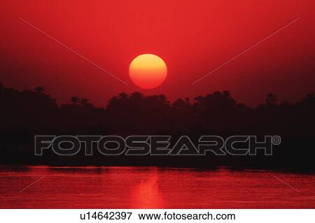 Stock Photo - A spectacular view of sunset in Luxor, Egypt. Fotosearch