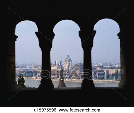 Stock Photograph - Budapest city and Danube river seen between pillars in Budapest Hungary. Fotosearch