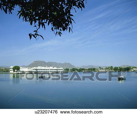 Stock Photograph - Distant view of Lake Palace, Pichola Lake, Udaipur, India. Fotosearch
