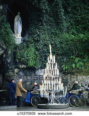 Large group of candles ignited near Virgin Mary in Lourdes, France View Large Photo Image Stock Photography - Large group of candles ignited near Virgin Mary in Lourdes, France. Fotosearch