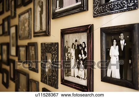 Stock Photo - Antique Family Photographs Covering Wall. Fotosearch