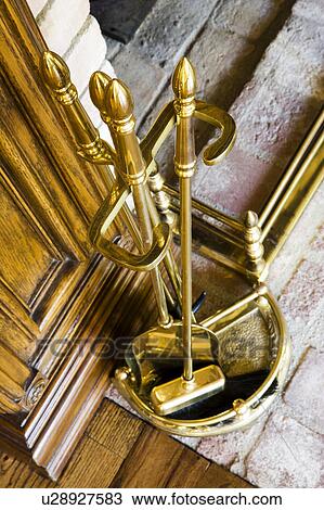 Stock Image - Brass bucket of fire utensils. Fotosearch