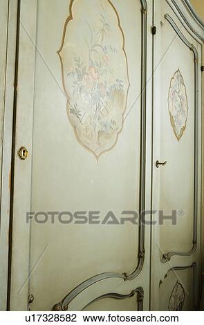 Stock Image - Hand Painting on Green Armoire. Fotosearch