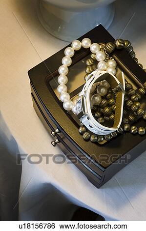 Stock Photograph - Jewelry Box with Necklaces and Watch on Top. Fotosearch