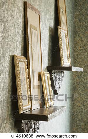 Stock Photo - Picture frames on shelf. Fotosearch