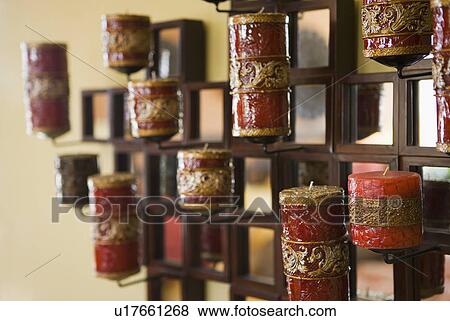 Stock Photo - Red candles in holder on wall. Fotosearch