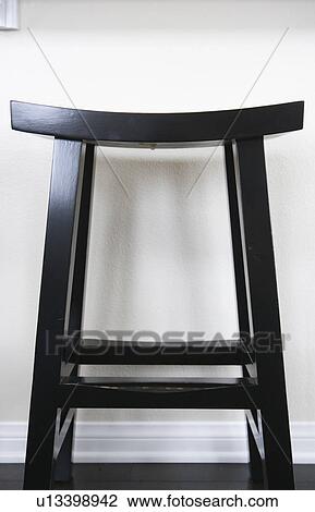 Stock Image - Black stool against white background. Fotosearch