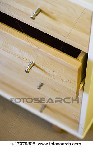 Stock Photo - Contemporary Chrome Knobs on Wood Dresser. Fotosearch