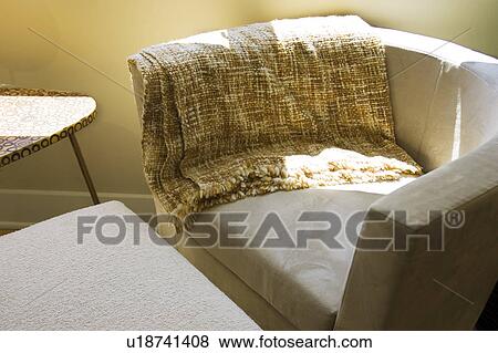 Stock Photo - Contemporary Suede Armchair and Ottoman. Fotosearch