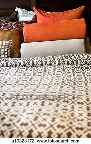 Stock Image - Detail of Colorful Patterned Bed Sheets and Pillows. Fotosearch