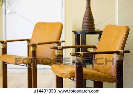 Stock Image - Wood and Leather Armchairs. Fotosearch