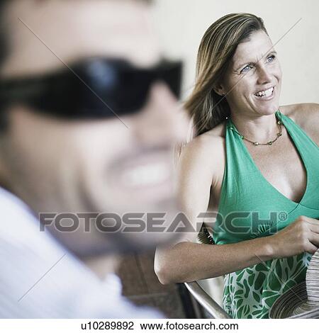 Mid adult woman smiling with a young man in the foreground View Large Photo Image Stock Image - Mid adult woman smiling with a young man in the foreground. Fotosearch