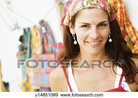 Portrait of a mid adult woman at a market stall and smiling View Large Photo Image Stock Photo - Portrait of a mid adult woman at a market stall and smiling. Fotosearch