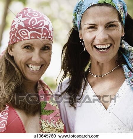 Portrait of two mid adult women smiling View Large Photo Image Stock Image - Portrait of two mid adult women smiling. Fotosearch