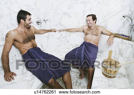 Two mid adult men sitting in the bathroom and smiling View Large Photo Image Stock Image - Two mid adult men sitting in the bathroom and smiling. Fotosearch