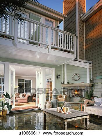 Stock Photo - Contemporary rear exterior with patio fireplace. Fotosearch
