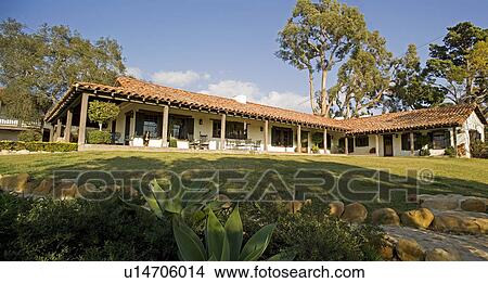 Picture - Exterior of Spanish style home and landscape. Fotosearch