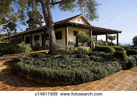 Stock Photo - Exterior of Spanish style home and landscape. Fotosearch