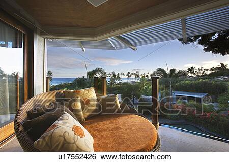 Stock Photograph - Large Round Orange Chair on Balcony. Fotosearch