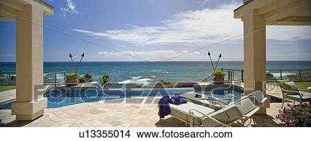 Large swimming pool and deck in coastal mansion View Large Photo Image Picture - Large swimming pool and deck in coastal mansion. Fotosearch