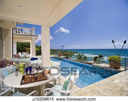 Picture - Large swimming pool and deck in coastal mansion. Fotosearch