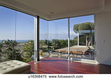 Modern living room with large windows View Large Photo Image Stock Photography - Modern living room with large windows. Fotosearch
