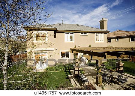 Rear exterior of home with large terrace patio View Large Photo Image Stock Photo - Rear exterior of home with large terrace patio. Fotosearch