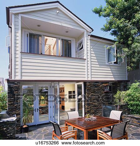 Stock Photograph - Rear exterior with patio. Fotosearch